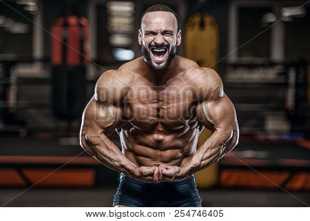 Brutal Strong Bodybuilder Athletic Men Pumping Up Muscles With Dumbbells