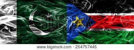 Pakistan Vs South Sudan Smoke Flags Placed Side By Side. Thick Colored Silky Smoke Flags Of Pakistan