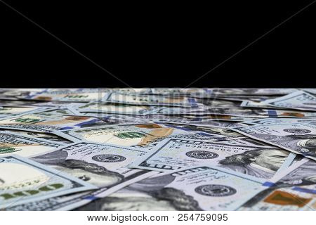 Stack Of One Hundred Dollar Bills Isolated On Black Background. Stack Of Cash Money In Hundred Dolla