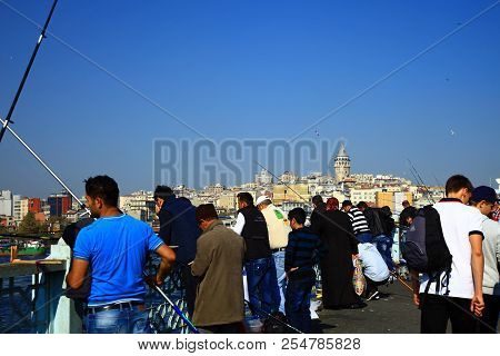 Istanbul, Turkey - 29 October, 2013: Men Fishing On The Galata Bridge In The Golden Horn, Istanbul. 