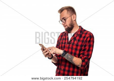 Message To Friend. Handsome Young Man Using Phone While Standing Againstwhite Background