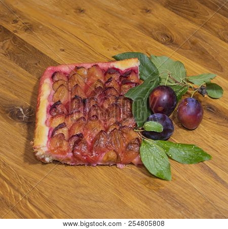 Piece Of Plum Cake And Fresh Plums On A Wooden Tray. The View From The Top