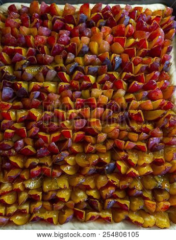 Background Of Bright Pieces Of Fresh Plum. The View From The Top.