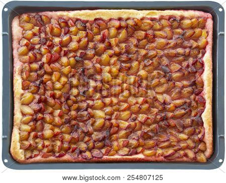 German Traditional Open Pie Made Of Plums On The Baking Sheet. Isolated On White Background