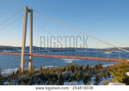 View At Hoga Kusten Bridge In Winter In Sweden. Hoga Kusten Suspension Bridge In Sweden.