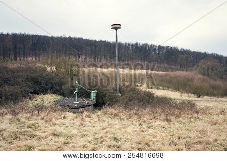 Old Pump With Leafless Forest, Water Shortage Scarcity Concept