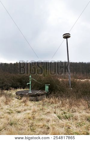 Old Pump With Leafless Forest, Water Shortage Scarcity Concept