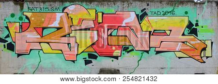 Full And Acomplished Graffiti Artwork. The Old Wall Decorated With Paint Stains In The Style Of Stre