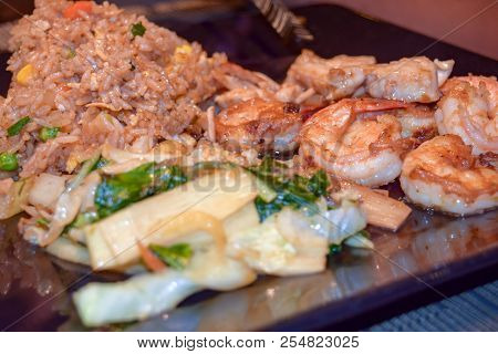 Plated Shrimp Meal With Fried Rice And Vegetable