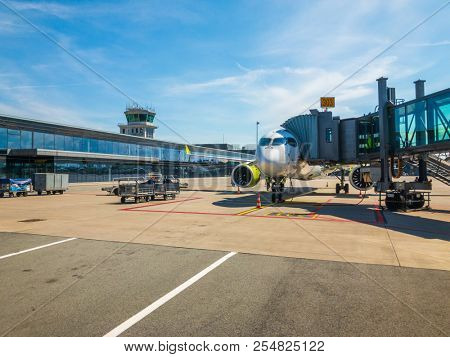 Riga, Latvia - July 8, 2018: Airbaltic airlines airplane boarding at the domestic airport at day time