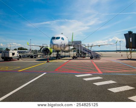 Riga, Latvia - July 8, 2018: Airbaltic airlines airplane boarding at the domestic airport at day time