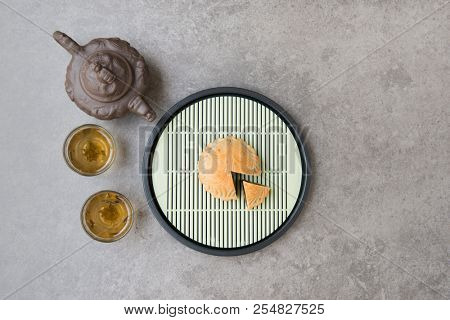 Traditional baked moon cakes is offered to friends or family during Mid-Autumn Festival. Flatlay on table top down view grey background with copy space. The Chinese character represent 