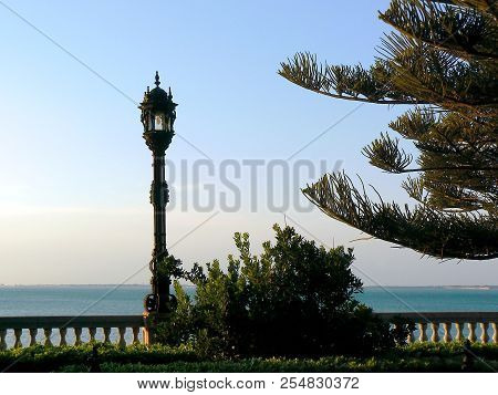 Lamppost Of Light In The Gardens Of Alameda Apodaca In Capital Of Cádiz, Andalusia. Spain. Europe.