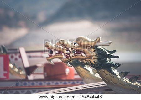 A Row Of Dragon Boats With The Traditional Figureheads