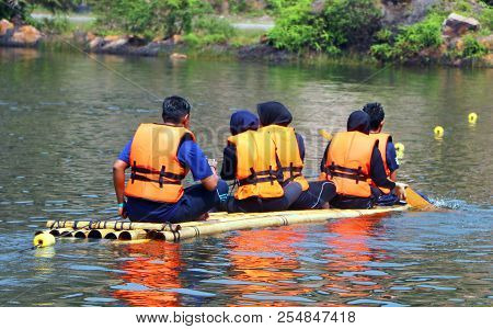 Banting, Selangor, Malaysia - July 28, 2018 : Tourist Rowing And Sitting On The Bamboo Raft Floating