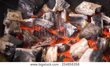 Tview Of Hot Flaming Charcoal Briquettes Glowing In The Bbq Grill Pit. Burning Coals For Cooking Bar