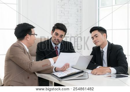 Asian Businessman Present Data Graph At Meeting Room In Office. Business Present And Meeting Concept