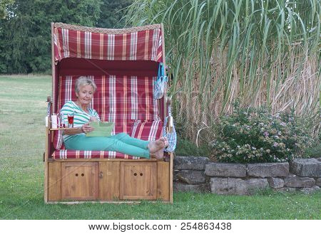 Write Emails In The Roofed Wicker Beach Chair On The Tablet, So You Can Spend Your Free Time