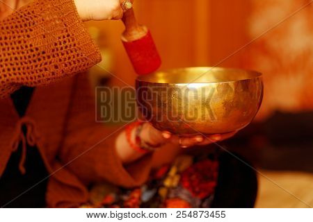 Spiritual Girl Immersed In Meditative Sounds Of Tibetian Bowl.