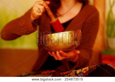 Spiritual Girl Immersed In Meditative Sounds Of Tibetian Bowl.
