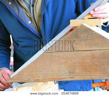Man Building A Wooden Boat For Usage Outdoors.