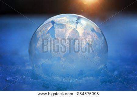 Frozen bubble with ice crystals in winter