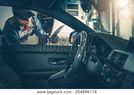 Auto Service Worker Inspection. Checking For Milage And On Board Computer Error Codes.
