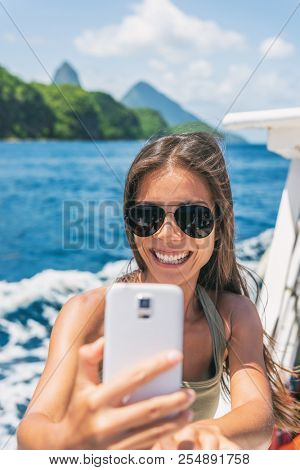 Cruise caribbean travel selfie tourist Asian girl on St Lucia Pitons mountains boat ride tour excursion. Summer sun holidays.