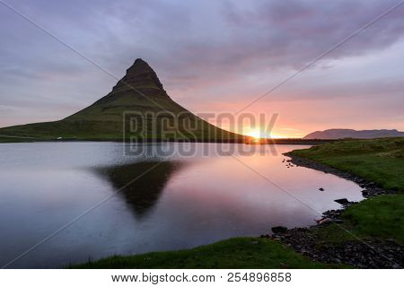 Colorful sunrise on Kirkjufellsfoss waterfall. Amazing morning scene near Kirkjufell volkano, Iceland, Europe. Landscape photography