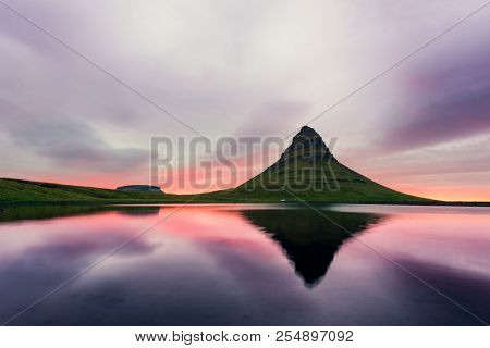 Colorful sunrise on Kirkjufellsfoss waterfall. Amazing morning scene near Kirkjufell volkano, Iceland, Europe. Landscape photography