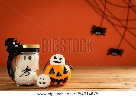 Halloween Crafts, Orange Pumpkin, Ghost And Spide On Wooden Table And Orange Background With Copy Sp