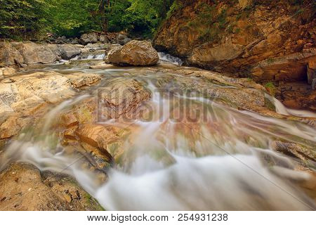 Waterfall In The Forest In Summer Time