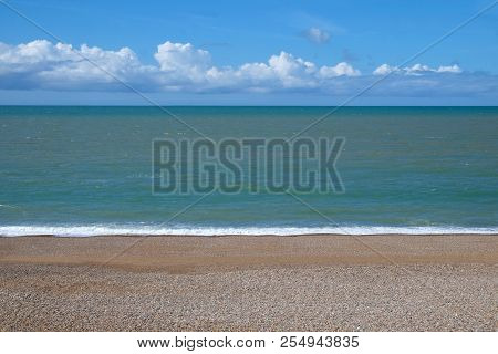 Beach Sea And Sky A Line Of Clear Pebble Yellow Beach At The Bottom In The Middle A Clear Blue Calm 