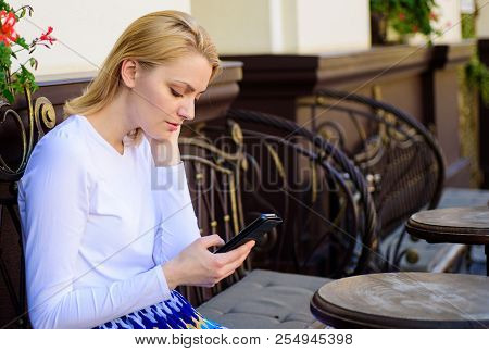 Whom Should I Text. Woman Calm Face Sit With Smartphone Cafe Terrace Urban Background. Girl Looking 