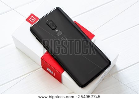 Khakiv, Ukraine - 14 August 2018: Smartphone OnePlus 6 on the white and red box and wooden table