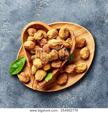 Sun Dried Apricots On Gray Concrete Background. Top View.