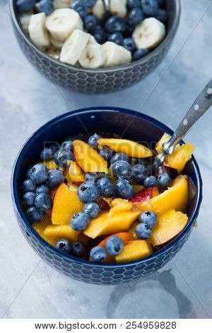 Breakfast Bowl With Oat Flakes And Fruits And Berries Like Blueberries , Nectarines And Bananas