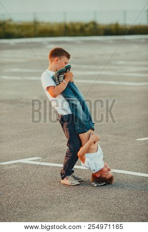 The Boy Standing Upside Down In The Summer Outdoors
