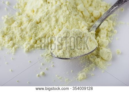 Purified Sulfur Powder On A White Acrylic Background