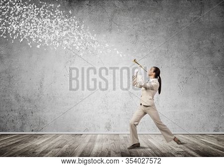 Woman Playing Trumpet Brass Instrument. Various Letters Flying Out From Trumpet. Young Businesswoman