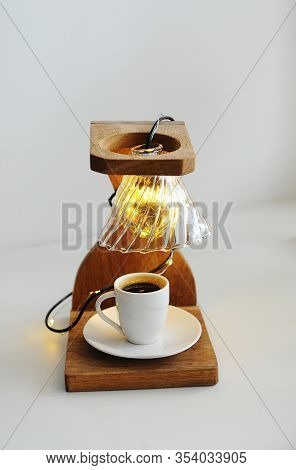 Creative Art Handmade Lamp Made Of Drip Coffee Station, V60 Dripper And Lights. Cup Of Black Coffee 
