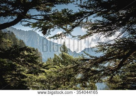 Hikers Climbing A Mountain Path In The Pyrenees In France