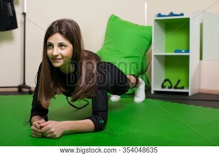 A Young Woman Doing Fitness Exercises In An Ems Suit. Concept: Health, Ems Training, Fitness In Ems 
