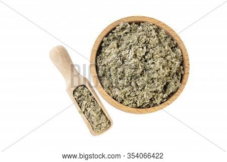 Dried Artichoke Leaves Or In Latin Cynarae Folium In Wooden Bowl And Scoop Isolated On White Backgro