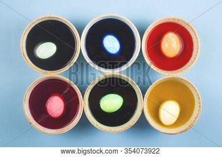 Eggs Are Painted In Different Colors In Colored Water With Dyes In Six Bowls.. Minimalistic Easter L