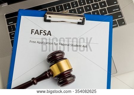 Document With Student Aid And Wooden Gavel On The Table With Laptop Isolated. Fafsa
