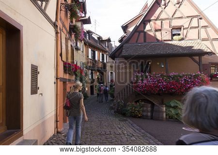 Beautiful View Of Charming Street Scene With Colorful Houses In The Historic Town Of Eguisheim On An