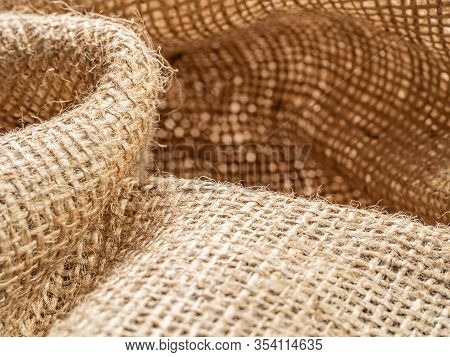 Brown Baline. Crumpled Burlap Fabric, Close Up View. Texture Of Brown Sackcloth. Crumpled Burlap Tex