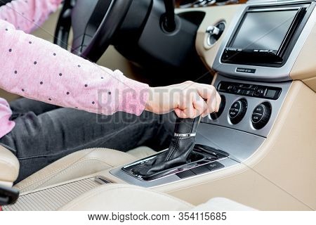 woman driver hand shifting the gear stick