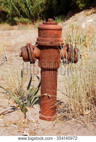 Old Rusty Hydrant On Waste Ground Isolated View